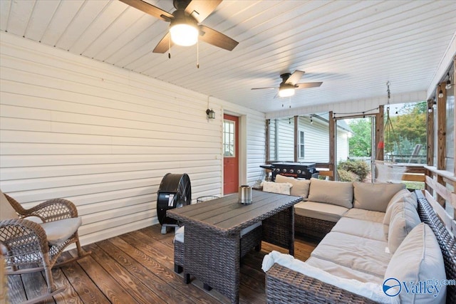 wooden terrace featuring grilling area and an outdoor hangout area