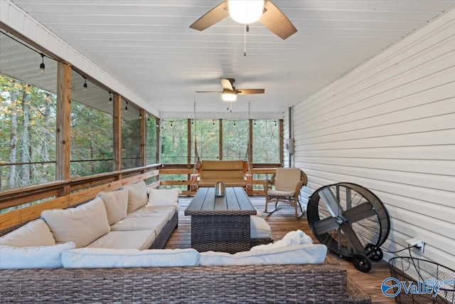 sunroom / solarium featuring ceiling fan and a healthy amount of sunlight