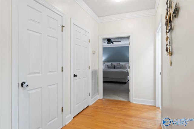 corridor with crown molding and wood-type flooring