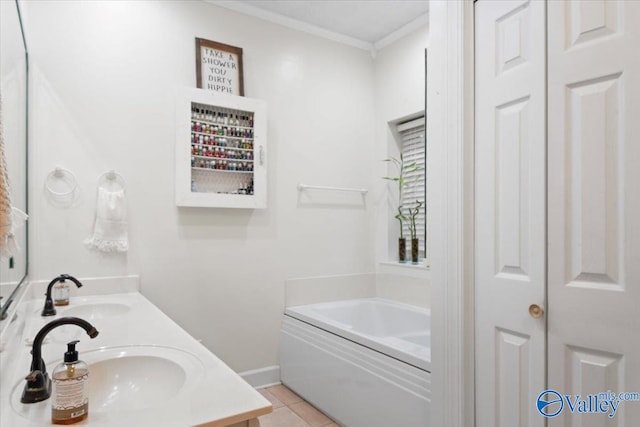 bathroom featuring tile patterned flooring, vanity, ornamental molding, and a washtub