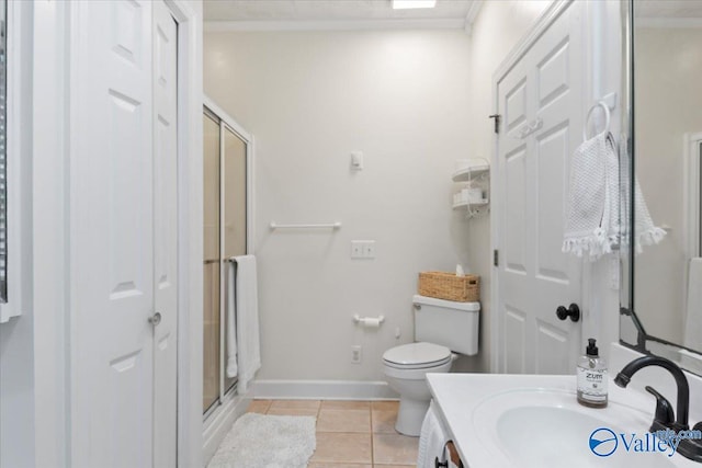 bathroom with tile patterned flooring, ornamental molding, an enclosed shower, and toilet