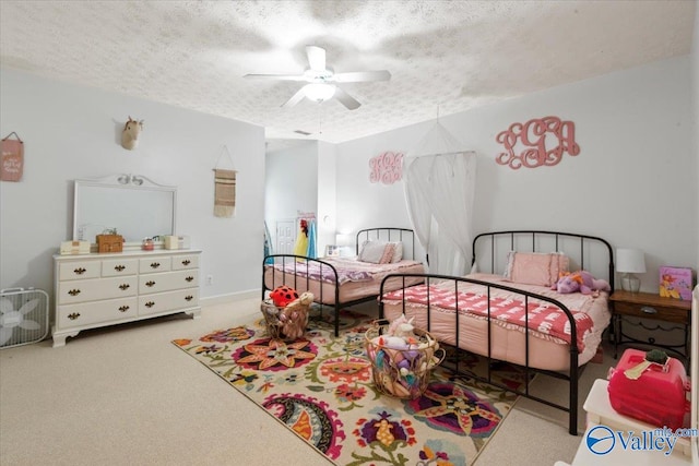 carpeted bedroom with a textured ceiling and ceiling fan