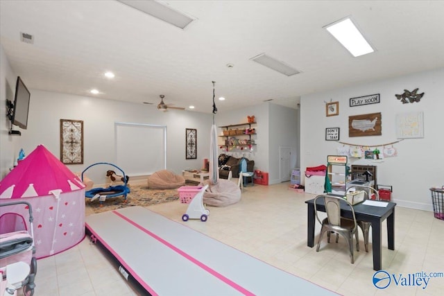 recreation room featuring light tile patterned floors and ceiling fan