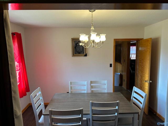 dining area featuring an inviting chandelier and dark hardwood / wood-style floors