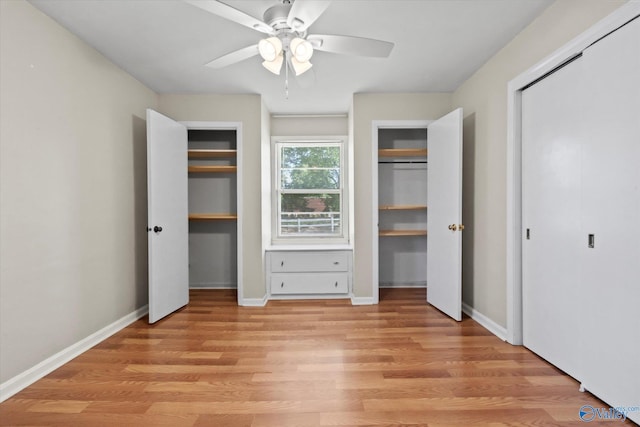 905 Cedar St SW, Decatur, AL 35601 - unfurnished bedroom with multiple closets, light wood finished floors, and baseboards