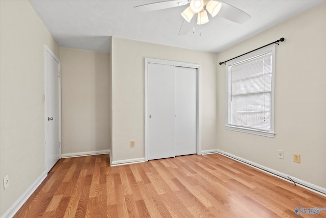 905 Cedar St SW, Decatur, AL 35601 - unfurnished bedroom with light wood-type flooring, baseboards, a closet, and a ceiling fan