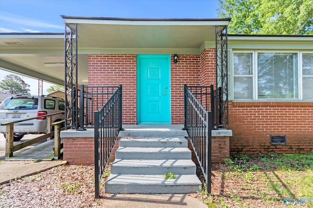905 Cedar St SW, Decatur, AL 35601 - entrance to property with brick siding, an attached carport, and crawl space