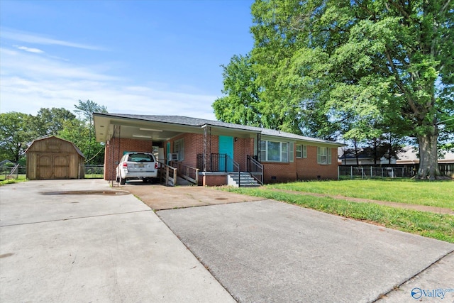 905 Cedar St SW, Decatur, AL 35601 - single story home with brick siding, concrete driveway, a storage shed, and an attached carport