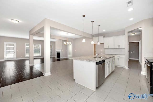 kitchen with visible vents, dishwasher, open floor plan, decorative light fixtures, and a sink