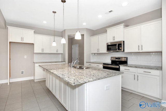 kitchen featuring white cabinets, a kitchen island with sink, stainless steel appliances, and a sink