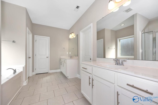 bathroom featuring baseboards, visible vents, two vanities, a sink, and a bath