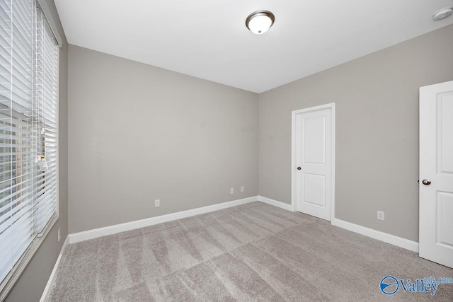 unfurnished bedroom with carpet flooring and baseboards