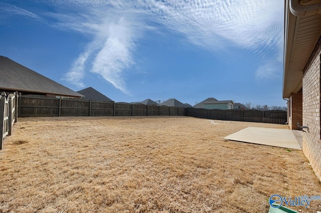 view of yard with a patio area and a fenced backyard