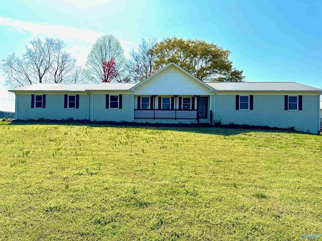 ranch-style home with a front yard, a standing seam roof, and metal roof