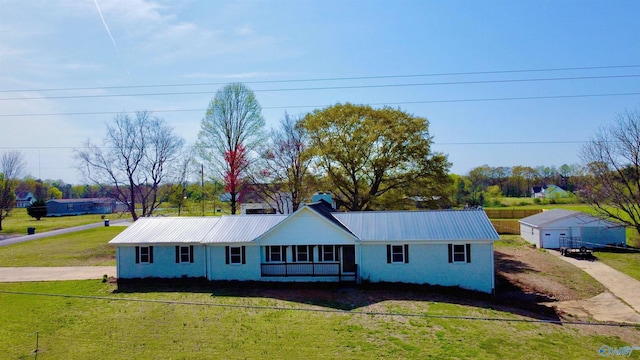 ranch-style house with a front lawn and metal roof