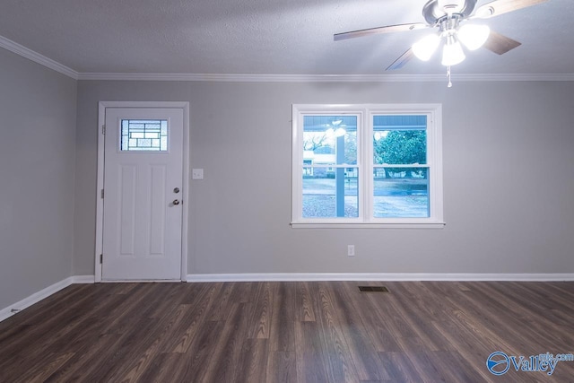 foyer with a wealth of natural light, crown molding, and dark wood-type flooring