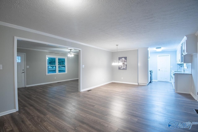 unfurnished living room with ceiling fan with notable chandelier, dark wood-type flooring, crown molding, and sink