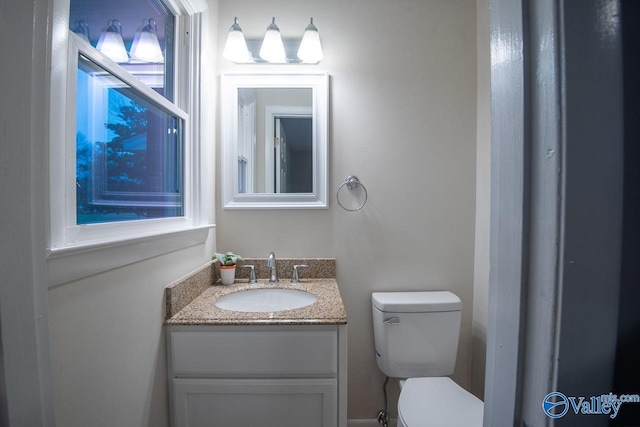 bathroom featuring vanity and toilet