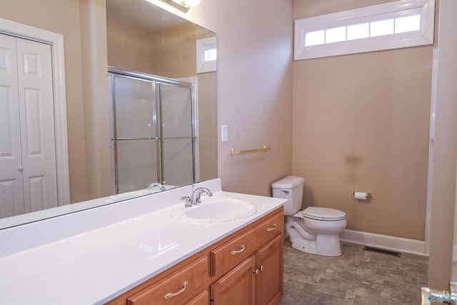 bathroom with vanity, toilet, and an enclosed shower