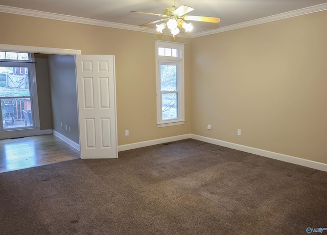 carpeted spare room featuring ceiling fan and ornamental molding