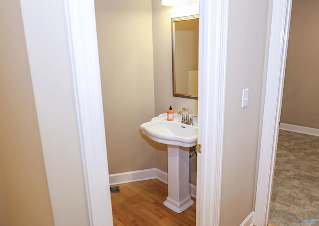 bathroom featuring wood-type flooring