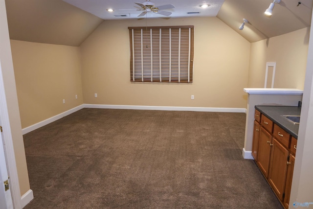 bonus room with ceiling fan, dark carpet, and lofted ceiling