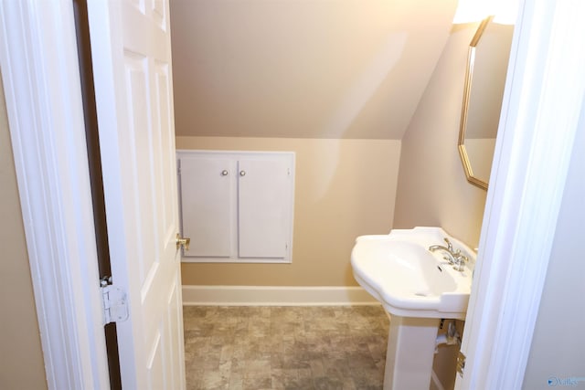 bathroom featuring vaulted ceiling