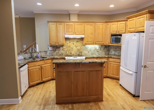 kitchen with dark stone countertops, sink, white appliances, and ornamental molding