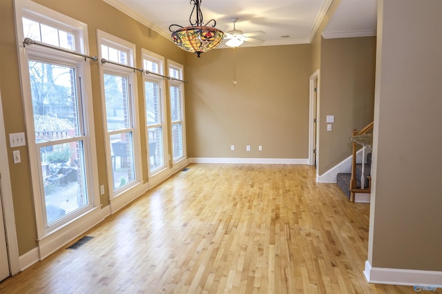 interior space with a wealth of natural light, ceiling fan, light hardwood / wood-style flooring, and crown molding