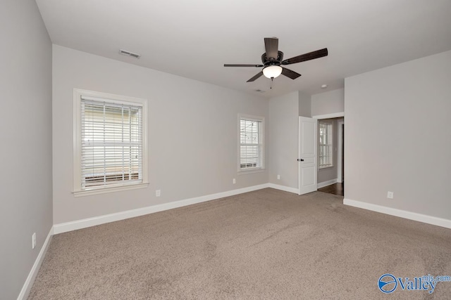 empty room with ceiling fan and carpet