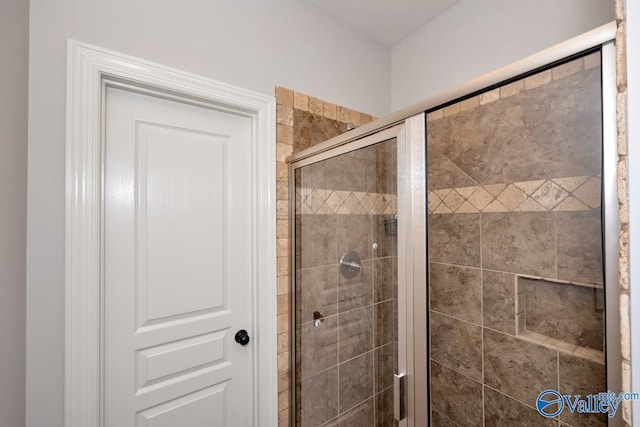 bathroom featuring a shower with shower door