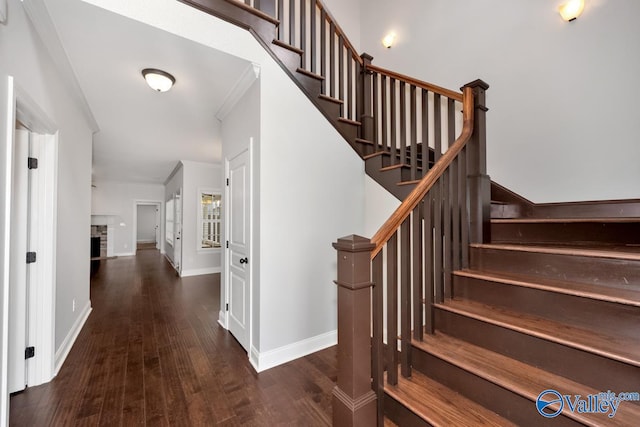 stairs featuring crown molding and hardwood / wood-style floors