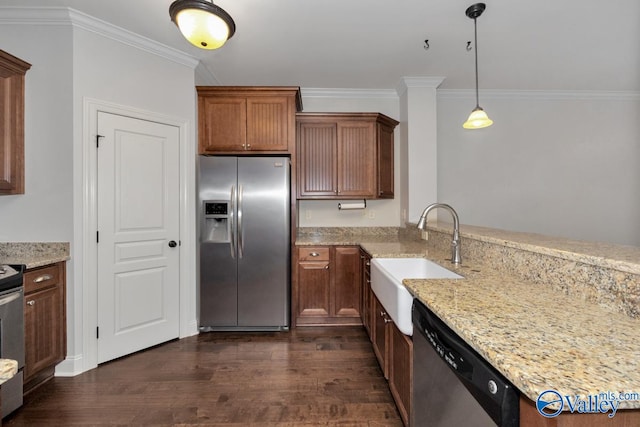 kitchen with sink, decorative light fixtures, dark wood-type flooring, stainless steel appliances, and light stone countertops