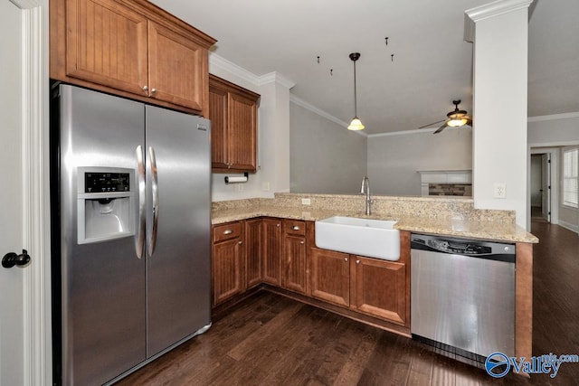 kitchen featuring appliances with stainless steel finishes, ornamental molding, sink, and dark hardwood / wood-style flooring