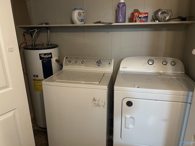 laundry room with electric water heater and washer and clothes dryer