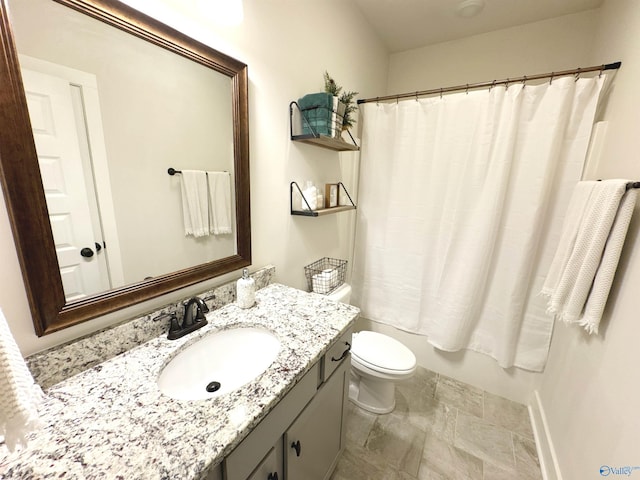 bathroom featuring toilet, shower / tub combo with curtain, and vanity