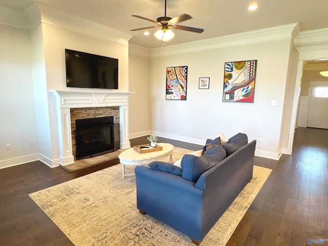 living room featuring crown molding, dark wood-style flooring, ceiling fan, a fireplace, and baseboards