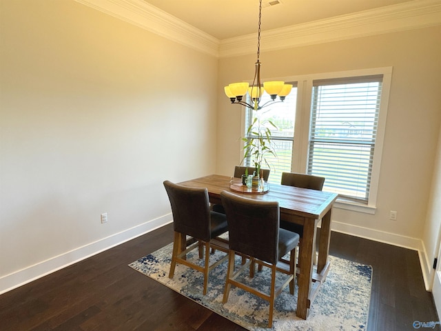 dining space featuring dark wood-style flooring, baseboards, a notable chandelier, and ornamental molding