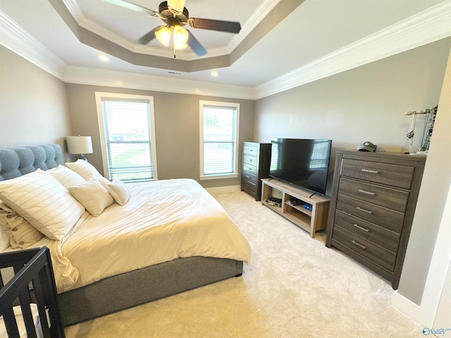 bedroom featuring crown molding, a raised ceiling, visible vents, and light carpet