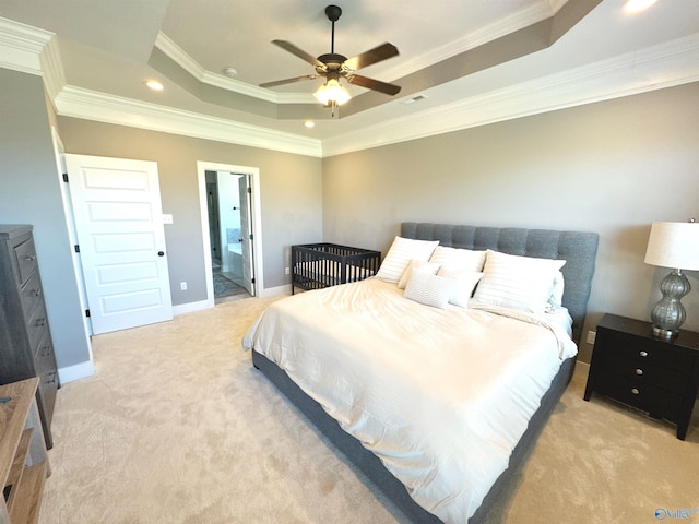 bedroom with light colored carpet, a raised ceiling, crown molding, and visible vents