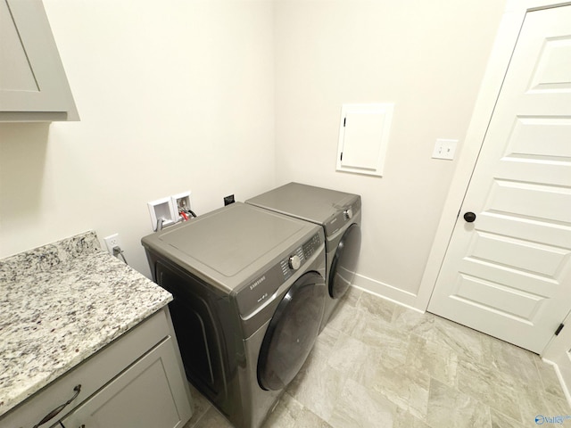laundry room with baseboards, cabinet space, and washing machine and clothes dryer
