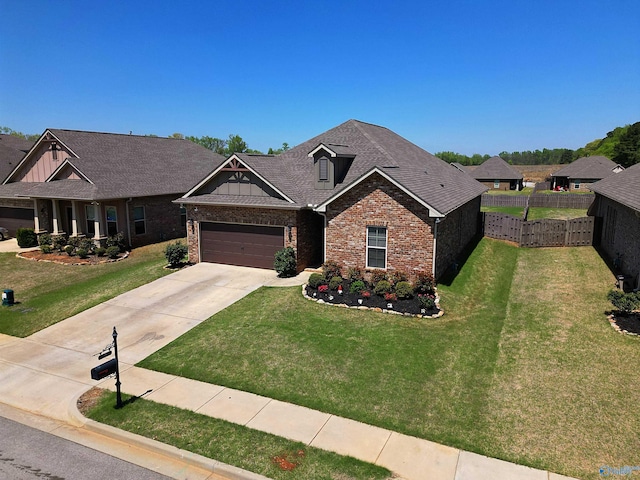 craftsman inspired home with a front lawn, fence, brick siding, concrete driveway, and an attached garage