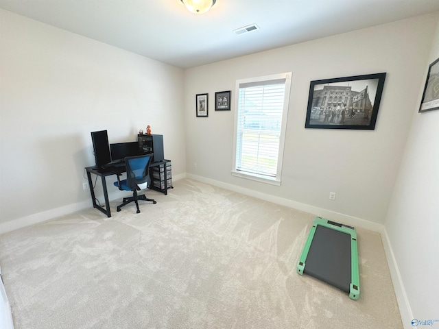 office space featuring carpet floors, baseboards, and visible vents