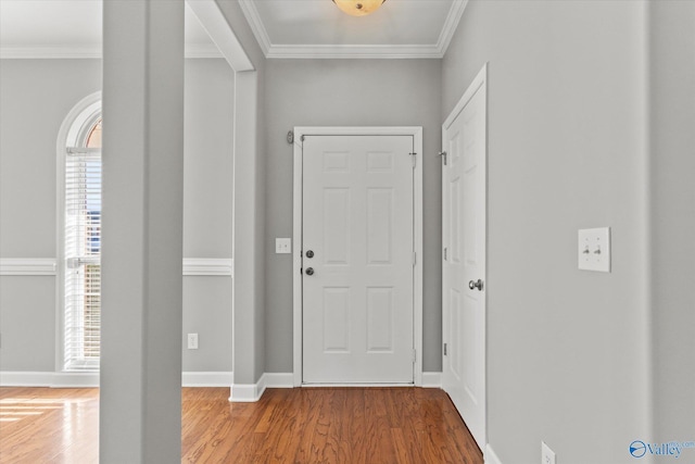 foyer with wood-type flooring and ornamental molding