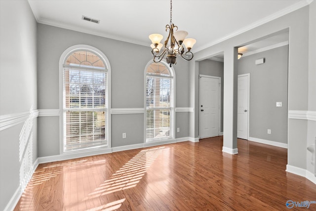 unfurnished dining area featuring crown molding, dark wood-type flooring, and a healthy amount of sunlight