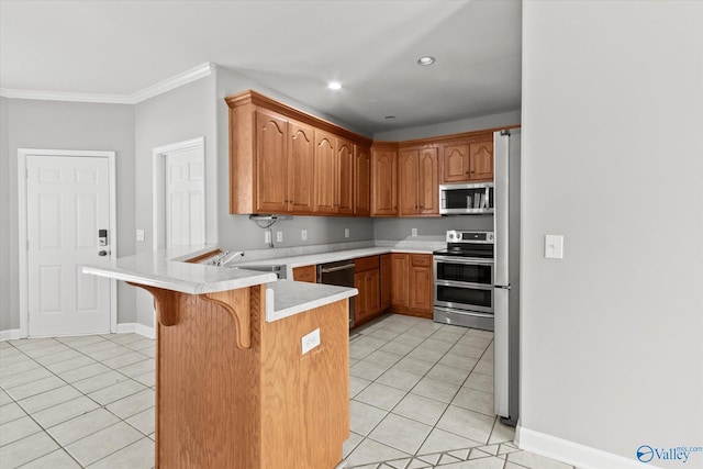 kitchen with sink, stainless steel appliances, kitchen peninsula, a breakfast bar area, and light tile patterned floors