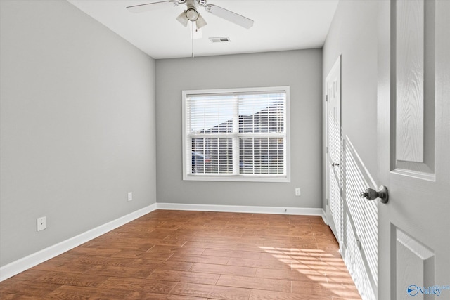 unfurnished room with hardwood / wood-style floors and ceiling fan