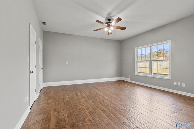 empty room with hardwood / wood-style flooring and ceiling fan