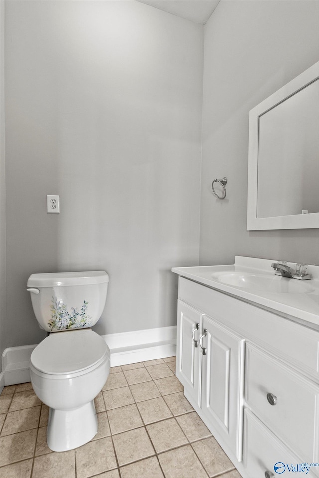 bathroom featuring tile patterned flooring, vanity, and toilet