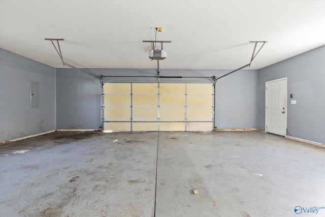 garage with electric panel and a garage door opener